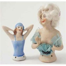Two early 20th century German porcelain Bathing Belle tea cosies, one with real hair, clapping po...