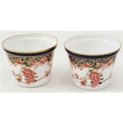 A pair of Royal Crown Derby flowerpots, printed with foliage in iron red against gilded blue bord...