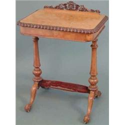 A Victorian satinwood work table, with floral carved scroll back and ovolo moulded border, over a...