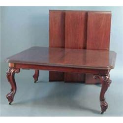 A large Victorian mahogany extending dining table, with rounded corners and three extra leaves on...