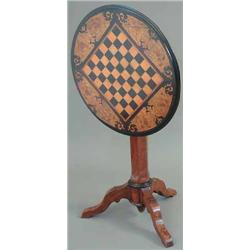 A 19th century Dutch walnut and ebonised circular top games table, with chess board and floral ma...
