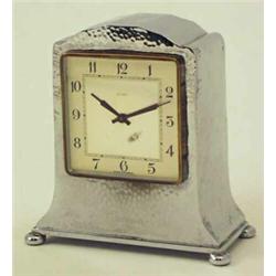 A Tudric chrome plated mantel clock, hammered finish with French spring-driven movement, case sta...