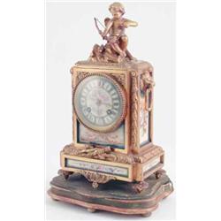 A late 19th century French ormolu mantel clock, with painted Sevres-type porcelain dial, Cupid fi...