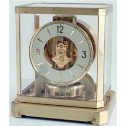 A Jaegar-Le Coultre Atmos mantel clock, enclosed within glass and brass case, movement visible wi...
