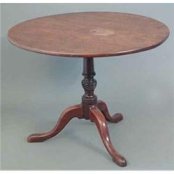 A George III mahogany circular occasional table, on turned and spiral fluted stem and tripod base...