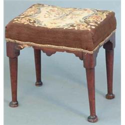A mid 18th century mahogany stool, with rectangular tapestry seat on tapered legs with pad feet (...