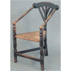 A Victorian Arts and Crafts stained oak wainscot chair, with turned arms and legs with rush seat...