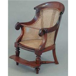 A George IV mahogany childs bergere high chair, with caned back and seat (lacks base, replaced fo...