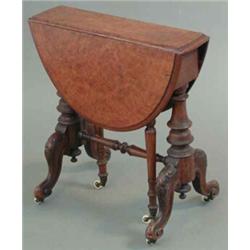 A small Victorian figured walnut oval top Sutherland table, on turned and carved end standards, 1...