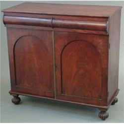 A William IV mahogany chiffonier, with convex frieze drawer and 2 doors below on reeded bun feet...