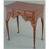 Image 1 : A George III oak lowboy, with 3 small drawers and shaped apron on slender tapered legs with pad f...