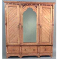 A Victorian Heals Arts and Crafts golden oak wardrobe, in the manner of Charles Bevan with castel...