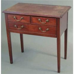 A George IV mahogany low boy, with one long and two short drawers, fitted brass loop handles on s...