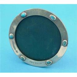A Liberty & Co 'Cymric' silver circular photograph frame, applied with six turquoise bosses, Birm...