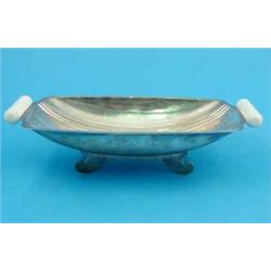 An Art Deco silver fruit bowl, of curved rectangular form with white plastic bar handles and scro...