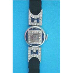 An Art Deco sapphire and diamond set platinum cocktail watch with square arabic dial....