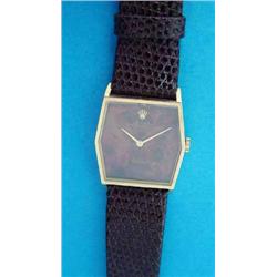 A lady's 18ct gold Rolex Cellini wrist watch, with angular case and tigers eye dial....