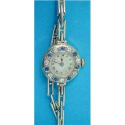 A lady's 18ct gold Rolex wrist watch, the bezel set with alternating sapphires and diamonds aroun...