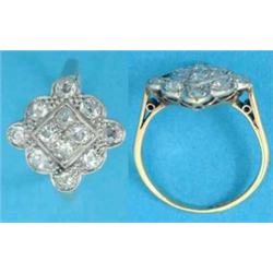 An 18ct gold dress ring, the lozenge shape bezel set with 12 old brilliant cut diamonds....