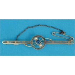 A 15ct gold openwork bar brooch, millegrain set with a square sapphire flanked by split pearls...