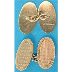 A pair of 18ct gold engine turned oval cufflinks, with chain link connections, 13.5grms, together...