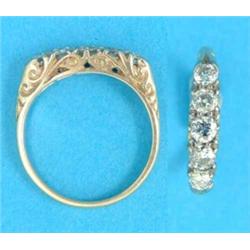 A Victorian gold 5-stone diamond half hoop ring, with scroll carved gallery and shoulders...