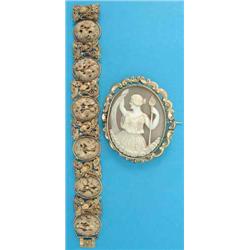 A 19th century gilt metal and ivory bracelet, designed as 8 oval floral carved ivory plaques, eac...