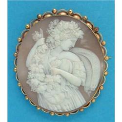 An oval shell cameo brooch, carved with a baccante, in 9ct gold beaded and scrolled frame, 2ins...