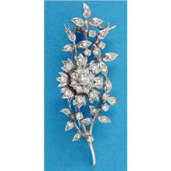 An 18ct white gold diamond set floral spray brooch...