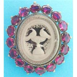 A Victorian gilt metal swivel portrait brooch, the frame set amethyst coloured pastes...