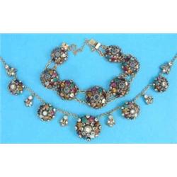 An Eastern gilt metal necklace, designed as 5 bombe shape clusters set semi precious gem stones,...