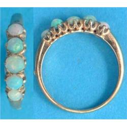 A 9ct gold half hoop ring, claw set 5 round opals...