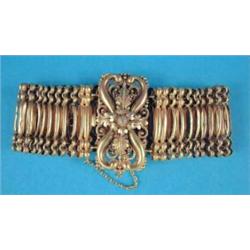 A 19th century bloomed gold flexible bracelet, of fancy linking, the rectangular repousse work cl...