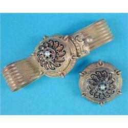 A 19th century gold jarretiere bracelet, the circular hinged locket front with dark blue enamel d...