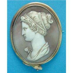 An early Victorian shell cameo brooch, carved with a classical profile study of a lady with a rib...