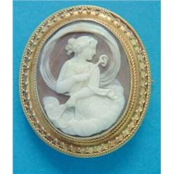 A Victorian shell cameo brooch, carved with a classical study of a nymph, in a gold frame with wi...