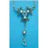 Image 1 : An Edwardian 15ct gold pendant necklace, of openwork scroll design, set with an aquamarine and se...