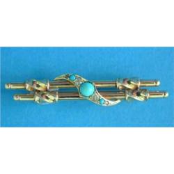 An Edwardian 15ct gold double bar brooch, with crossover front set 3 turquoises and 2 diamonds...