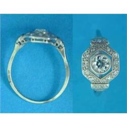 An Art Deco diamond ring, set with an old brilliant cut diamond in a hexagonal border of carre se...