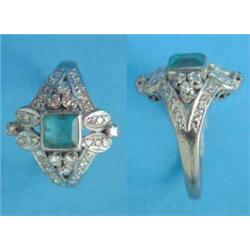 An 18k white gold Art Deco emerald and diamond ring, the central square cut emerald in an openwor...