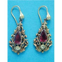 A pair of Victorian gold pear shape drop earrings, each set with a garnet and a peridot...