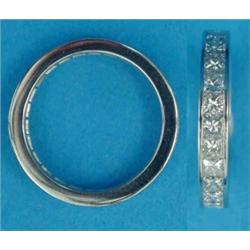 A platinum and diamond full eternity ring, channel set with 26 Princess cut stones, total weight...