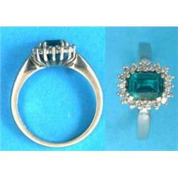 An 18ct white gold ring, set with a rectangular cut synthetic emerald and white stones...