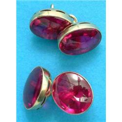 A pair of gold mounted cufflinks, set oval cabochon synthetic rubies (cased)...