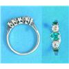 Image 1 : An 18ct white gold and platinum half hoop ring, claw set 3 rectangular cut emeralds and 2 round-c...