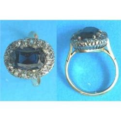 An 18ct gold, sapphire and diamond oval cluster ring...