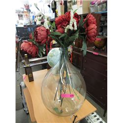 Glass demijohn with imitation flowers