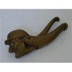 A NOVELTY TREEN NUTCRACKER, Tryolean, early 20th century, formed as a grinning jockey, length 21c...