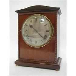 AN EDWARDIAN MAHOGANY BRACKET CLOCK, carved pediment, 15cm silvered Roman dial, movement signed '...