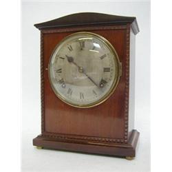 AN EDWARDIAN MAHOGANY BRACKET CLOCK, carved pediment, 15cm silvered Roman dial, movement signed '...